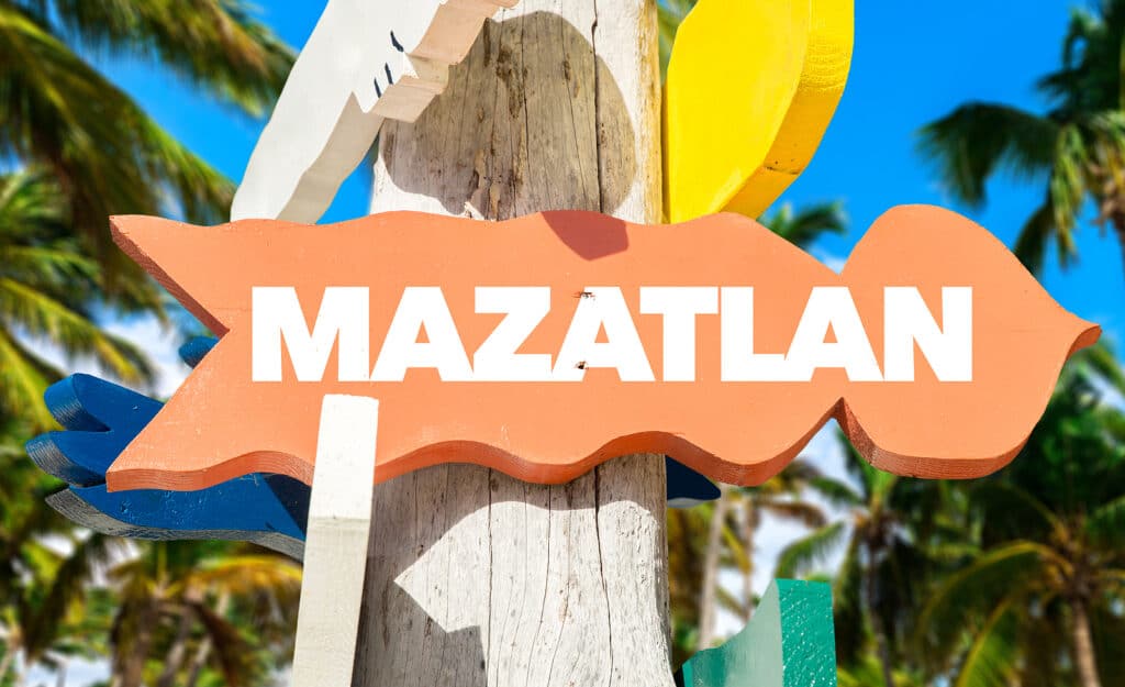 Mazatlan welcome sign with palm trees by Vacancy Rewards