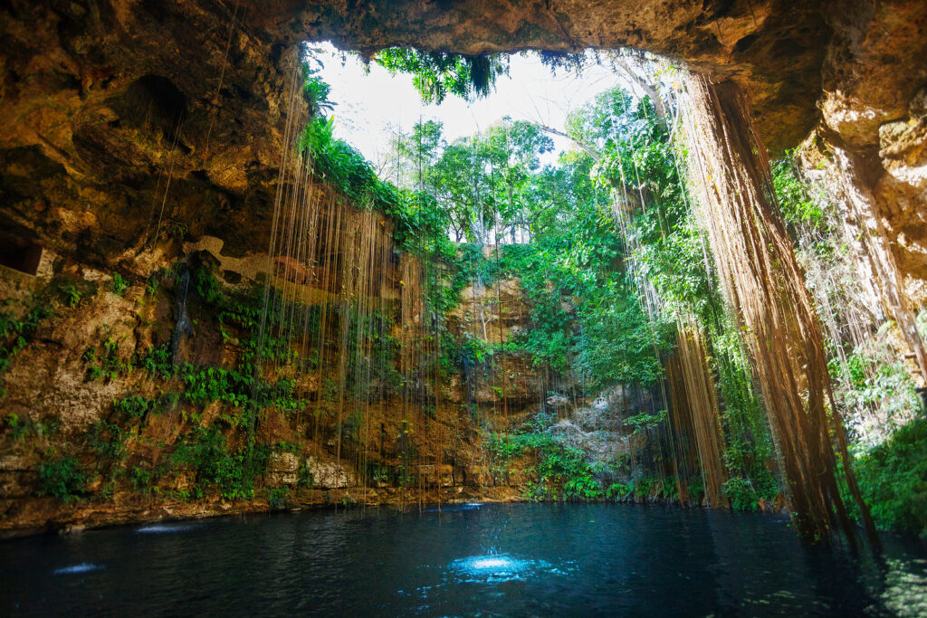 Sunbeams penetrating at Ik-Kil cenote inlet opening, Mexico