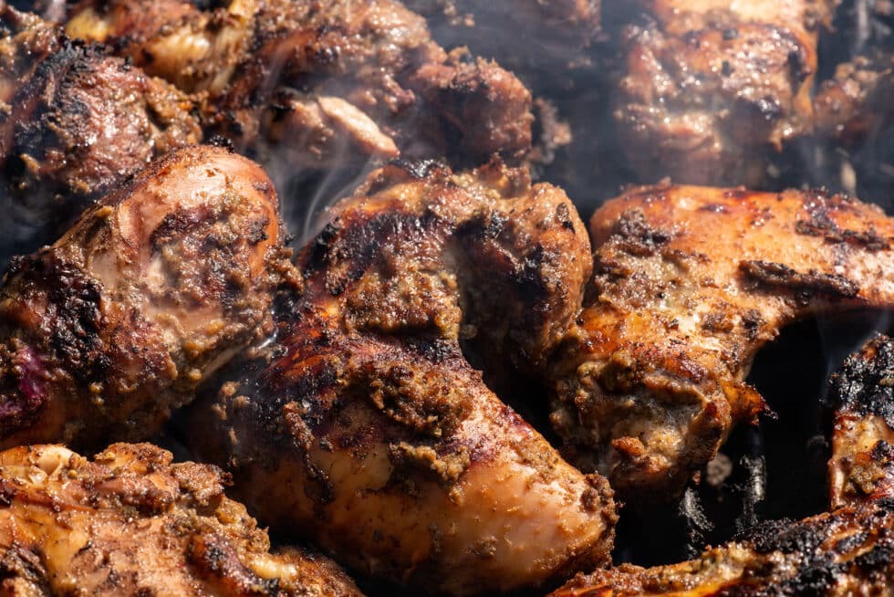 Vacancy Rewards Reviews showcases jerk chicken, one of Jamaica's best-known dishes, prepared with bold spices and smoky flavor.